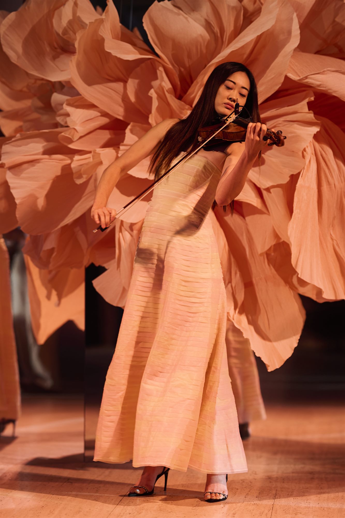 Rose Magnitude — violinist performing inside the giant paper rose